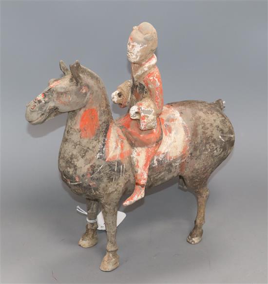 A Chinese painted pottery funerary equestrian figure, believed to be Western Han Dynasty, H 32cm
